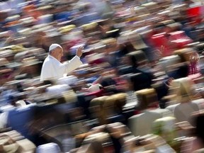 Pope Francis waves as he arrives to lead the weekly audience in Saint Peter's Square at the Vatican April 22, 2015. REUTERS/Max Rossi