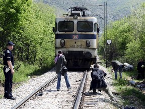 Media and police inspect at the scene where fourteen migrants were hit by a train, near Veles  April 24, 2015. Fourteen migrants were hit by a train and killed in central Macedonia late on Thursday as they walked through a canyon along an increasingly well-trodden Balkan route for migrants trying to reach western Europe.The accident happened at around 10.30 p.m. (2030 GMT) near the central city of Veles. Rescue efforts were hampered by difficult terrain, with the site of the accident accessible only by foot or railway.  REUTERS/Ognen Teofilovski