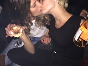 Miley Cyrus kissing an unknown woman in Las Vegas. (Instagram)