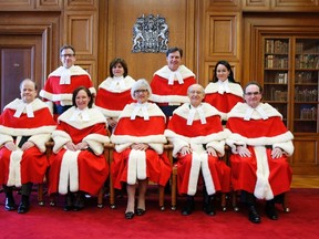 The Supreme Court of Canada Justices (front L-R) Thomas Cromwell, Rosalie Abella, Beverley McLachlin, Marshall Rothstein, Michael Moldaver, (back L-R) Clement Gascon, Andromache Karakatsanis, Richard Wagner, Suzanne Cote pose for a photo before a ceremony at the Supreme Court of Canada in Ottawa February 10, 2015.    REUTERS/Blair Gable