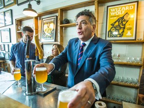 Finance Minister Charles Sousa during a beer pouring photo-op after speaking Bellwoods Brewery about the budget plan on Friday, April 24, 2015. (ERNEST DOROSZUK/Toronto Sun)