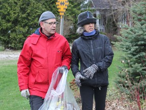Greg Smith and co-organizer Elise Feltrin take part in the Bayfield River Valley Trails Association’s “Litter Walk” by cleaning up garbage on Victoria Street in Bayfield. (Laura Broadley Clinton News Record)