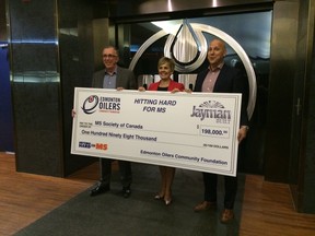 Jayman BUILT’s Pierre Sareault (right) presented a cheque for $198,000 to MS Society - Alberta and NWT president Neil Pierce (left) and Oilers Community Foundation executive director Natalie Minckler on April 16 at Rexall Place.