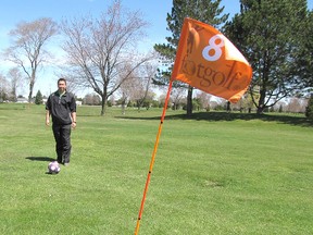 Brett Fujii, an employee at Country View Golf Course, lines up his next FootGolf shot on the course near Chatham. Country View is the latest course to offer the emerging sport that mixes golf with soccer. (Blair Andrews/Chatham This Week)