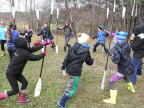 Students taking part in an environmental summit near Gananoque warm up in the chilly morning by playing a game in which they have to grab the kayak paddles before they fall. About 75 Grade 5 students from the area learned about species at risk as well as other environmental issues. APR. 23, 2016 GANANOQUE ONT. MICHAEL LEA THE WHIG STANDARD