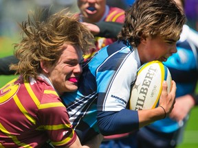 Banting's Adam Redgrift attempts to stop Lucas' Adam Cox from getting his third try of the first half of the their pre-season rugby game. Lucas won 31-7 over Banting. (Mike Hensen/The London Free Press)