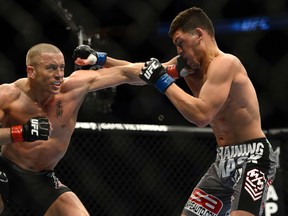 Canadian Georges St. Pierre connects with a left during his fight with Nick Diaz at UFC 158 in Montreal. (Postmedia Network file photo)