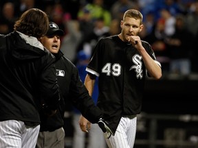Umpire Tim Timmons walks Jeff Samardzija (left) and Chris Sale (49) of the Chicago White Sox off the field after a brawl in the seventh inning April 23, 2015 at U.S. Cellular Field in Chicago. (Jon Durr/Getty Images/AFP)
