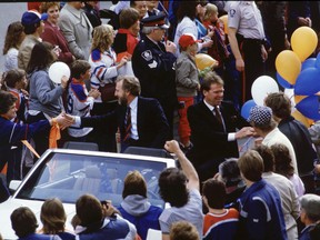 Edmonton Alberta--May 22, 1984--Edmonton Oilers owner Peter Pocklington and Coach and General Manager Glen Sather make their way through the crowd during the parade to celebrate the teams first Stanley Cup at the Edmonton Coliseum on May 19, 1984. The Edmonton Oilers defeated the Winnipeg Jets 3 to 0, the Calgary Flames 4 to 3, the Minnesota North Stars 4 to 0 and the New York Islanders 4 to 1 to win their first NHL championship. Edmonton Sun/QMI Agency