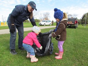 Cathy Halsall and her grandchildren, Juliet Ramon, 1, Claire Ramon, 3, were part of a crew of volunteers from MPM picking up trash at Rainbow Park during the city Parks and Recreation Department's First Annual Community Parks Cleanup Day on Saturday April 25, 2015 in Sarnia, Ont. Paul Morden/Sarnia Observer/Postmedia Network