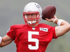 Quarterback Tim Tebow throws a pass at the New England Patriots training camp in Foxboro, Massachusetts, in this file photo taken July 26, 2013. (REUTERS/Dominick Reuter/Files)