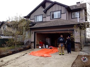 Fire investigators on scene at a 5 home house fire on Rutherford rd and 20 ave. Perry Mah/Edmonton Sun/Postmedia Network