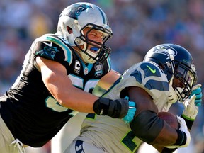 Luke Kuechly (left) of the Carolina Panthers tackles Robert Turbin of the Seattle Seahawks during NFL play at Bank of America Stadium October 26, 2014 in Charlotte, N.C. (Grant Halverson/Getty Images/AFP)