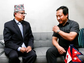 Nepal's Ambassador to Canada,Kali Pokhrel, speaks with Brampton resident Vishal Burathoki on April 25, 2015 about the deadly earthquake that struck their homeland. (Veronica Henri/Toronto Sun)