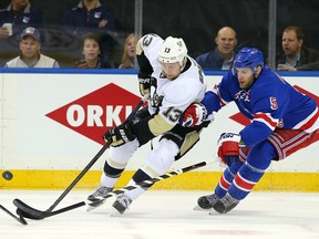 Pittsburgh Penguins centre Nick Spaling (13) has the puck knocked away by New York Rangers defenceman Dan Girardi during Game 5 of their first-round playoff series at Madison Square Garden. (Adam Hunger/USA TODAY Sports)