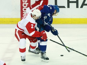 Detroit Red Wings defenseman Brendan Smith (2) and Tampa Bay Lightning left wing Ondrej Palat (18) skate to control the puck during the first period in game five of the first round of the 2015 Stanley Cup Playoffs at Amalie Arena. Mandatory Credit: Kim Klement-USA TODAY Sports