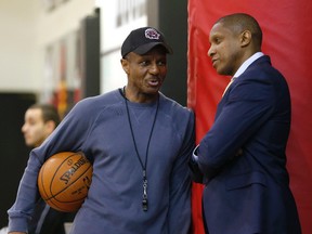 Raptors coach Dwane Casey and GM Masai Ujiri chat.prior to the start of their first-round playoff series against the Wizards. (JACK BOLAND/TORONTO SUN)