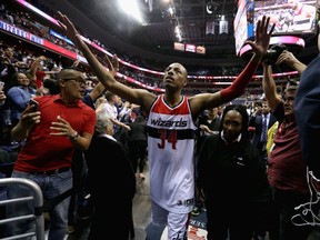 Raptors killer Paul Pierce of the Wizards celebrates with Washington fans after their 106-99 win over Toronto in Game 3 Friday night at the Verizon Center. (GETTY IMAGES)