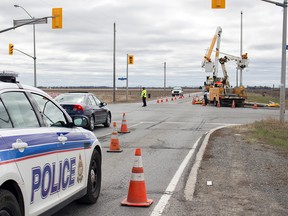 Crews work to restore power to traffic lights on Sunday April 26, 2015, near Fallowfield Rd. and Eagleson Rd. in Ottawa's west end following a fatal crash that claimed the life of a 23-year-old man.
DANI-ELLE DUBE/Ottawa Sun/Postmedia Network
