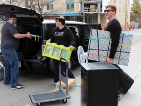 Jake Knight just finished his first year in Queen's University life sciences program. He gets help moving back to Barrie, Ont., for the summer from parents Jamie Knight and Matt Guio in Kingston, Ont. on Sunday April 26, 2015. Steph Crosier/Kingston Whig-Standard/Postmedia Network