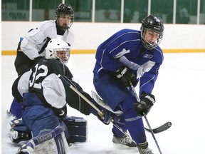 Sudbury Wolves first-round draft pick David Levin tries to stickhandle the puck around goalie Jake McGrath in Sudbury, Ont. on Sunday April 26, 2015.The Wolves held their spring orientation camp this past weekend.