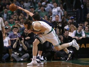 Kevin Love of the Cleveland Cavaliers reaches for a loss ball against Kelly Olynyk of the Boston Celtics in the first half in Game 4 during the first round of the 2015 NBA playoffs on April 26, 2015 at TD Garden. (Jim Rogash/Getty Images/AFP)