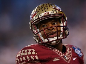 Jameis Winston of the Florida State Seminoles warms up before the game against the Georgia Tech Yellow Jackets at the ACC Championship game on December 6, 2014. (Mike Ehrmann/Getty Images/AFP)