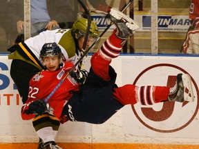 Generals’ Anthony Cirelli is taken down by Austin Kosack of the North Bay Battalion during Game 2 on Sunday night in Oshawa. (STAN BEHAL/TORONTO SUN)
