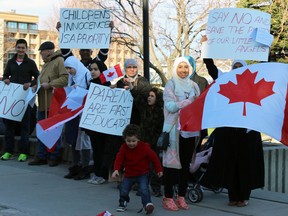 Parents and families gather in front of Kingston City Hall on Saturday afternoon to protest the new sexual education curriculum. (Steph Crosier/The Whig-Standard)