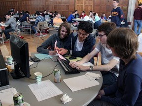 Frontenac Secondary school students from left, Ben Rosebery, Rafael Rodriguez, Brandon Turner and Mark Richmond compete in the Educational Computing Organization of Ontario's East Regional Programming Contest hosted at Queen's University on Saturday. (Steph Crosier/The Whig-Standard)
