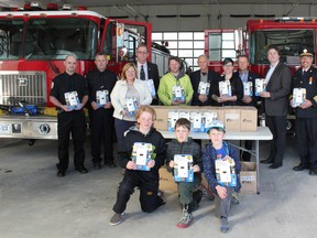 On hand to receive the carbon monoxide detectors were, back row from left to right, Chris Baldwin, Paul Gauthreau, MPP Lisa Thompson, Councillor Alex Westerhout, Bluewater Mayor Tyler Hessel, Councillor Dave Roy, Councillor Marnie Hill, Central Huron Mayor Jim Ginn, Doug DeRabbie from IBA, Fire Chief Dave Renner and Deputy Fire Chief Adam Wilson. Front row, left to right, Odin Hessel, Riley Hill and John Hill. (Laura Broadley Clinton News  Record)