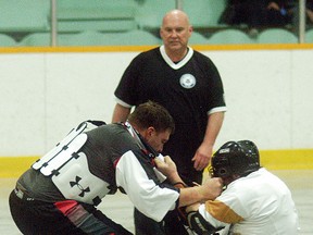 Wallaceburg Thrasher player Dustin Howlett, right, gets tangled up with a Six Nations player during a game played at Wallaceburg Memorial Arena on April 25. The game was the Thrashers' regular season and home opener. Six Nations won 10-7.
