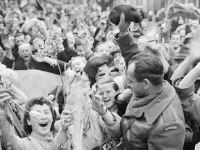 Dutch civilians celebrate the arrival of Canadian Corps troops in Utrecht after the German surrender, May 7, 1945. (Library and Archives of Canada)