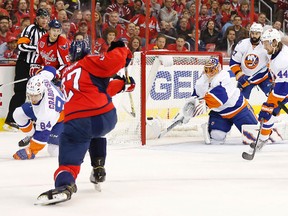 Caps defenceman Karl Alzner beats Isles' Jaroslav Halak during Game 5 of a series that will be decided tonight. (USA Today Sports)
