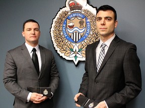 Constables Jason Priddle and Dave Ferrara stand with their badges Monday after being sworn in as Sarnia Police officers. (Tyler Kula/Sarnia Observer/Postmedia Network)