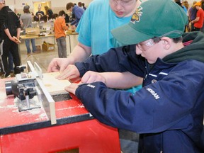 Ian Dufton (left), of St. Michael Catholic Secondary School, assists St. Columban student Ray Horan on the router machine on the woodworking station during the Huron-Perth Catholic District School Board’s 5th annual Ontario Youth Apprenticeship Program (OYAP) Grade 7 technology days at the Mitchell & District Community Centre last Monday, April 20. ANDY BADER/MITCHELL ADVOCATE
