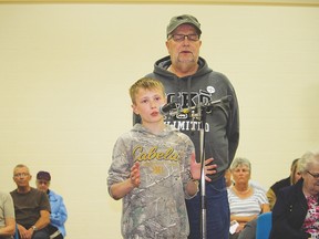 Ethan Krause, with grandfather John Van Spankeren standing behind him, directs a question to the local candidates during the candidates’ forum on April 22 in the gymnasium of Vulcan Prairieview Elementary school. Derek Wilkinson Vulcan Advocate
