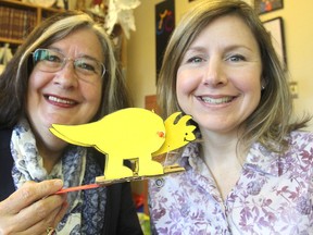 Lynda Colgan, left, and Kim Garrett, from the Community Outreach Centre in the Queen's faculty of education, hold a simple project that can be made by children attending the annual Science Rendezvous Kingston at the Rogers K-Rock Centre on May 9. (Michael Lea/The Whig-Standard)