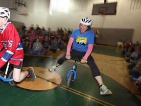 Student at St. Michael Catholic School in Belleville, Ont. and Montreal Canadiens fan Brandon Orr races local message therapist Cloud Nehrling during one of the first stops of this year's Pedal For Hope tour Monday, April 27, 2015. Belleville police officers, as well as surrounding OPPs', will be pedalling to upwards of 30 area-elementary schools until May 8 to spread a positive message of hope, healing and healthy living to thousands of children to help fight childhood cancer. - Jerome Lessard/Belleville Intelligencer/Postmedia Network