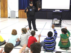 CN Police Const. Philip Cyr talks to students at Collins Bay Public School about train safety Monday morning at the start of National Rail Safety Week. (Michael Lea/The Whig-Standard)