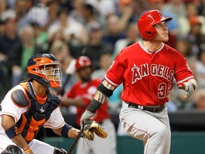 Josh Hamilton of the Los Angeles Angels hits a home run in the fifth inning as Houston Astros catcher Carlos Corporan watches at Minute Maid Park April 5, 2014 in Houston. (Bob Levey/Getty Images/AFP)