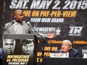 Eleven-time world boxing champion Floyd Mayweather (left) speaks at a news conference ahead of his upcoming bout with eight-division world champ Manny Pacquiao in Los Angeles March 11, 2015. (REUTERS/Lucy Nicholson)