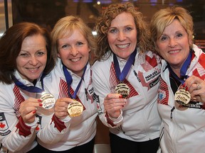 The Lois Fowler rink (l-r) Allyson Stewart, Cathy Gauthier, Maureen Bonar and Lois Fowler display their gold medals upon their  arrival in Winnipeg, Man. Monday April 27, 2015 after winning the World Senior Women's Curling Championship.
Brian Donogh/Winnipeg Sun/Postmedia Network