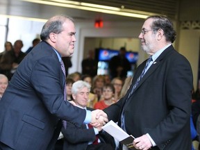 Gino Donato/The Sudbury Star  
Leo Gerard, chair of the CROSH advisory board, right, shakes hands with with Dominic Giroux at the official opening of the CROSH centre for research in occupational safety and health at Laurentian University on Monday.