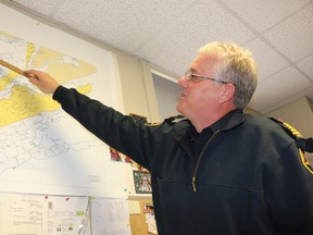 BRUCE BELL/STAFF REPORTER
Prince Edward County fire chief Scott Manlow points out on a map where a suspicious marsh fire burned for 12 hours on April 11.