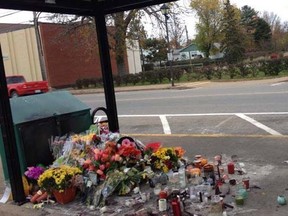Flowers are left inside a bus shelter in Berwick, N.S., where the body of 62-year-old Harley Lawrence was discovered after a fire in the early morning hours of Oct. 23, 2013. (Facebook/Postmedia Network)