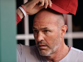 Manager Kirk Gibson of the Arizona Diamondbacks looks over the lineup in the dugout before a game against the Cincinnati Reds at Great American Ball Park on July 29, 2014. (Jamie Sabau/Getty Images/AFP)