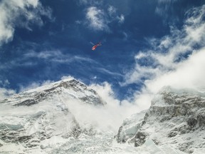 A rescue helicopter is shown above the Mount Everest south base camp in Nepal a day after a huge earthquake-caused avalanche, in this photo courtesy of 6summitschallenge.com taken on April 26, 2015 and released on April 27, 2015. One avalanche killed 18 climbers at base camp on Mount Everest, while 250 people were missing following a separate avalanche near Ghodatabela.  REUTERS/6summitschallenge.com