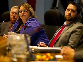 (Left to right) Trustees Ray Martin, board chair Sarah Hoffman and Michael Janz listen as Edmonton Public Schools superintendent Darrel Robertson speaks to the school board about his decisions regarding overcrowding in Edmonton schools at the Centre for Education in Edmonton, Alta., on Tuesday, Feb. 18, 2014. The Ian Kucerak/Edmonton Sun