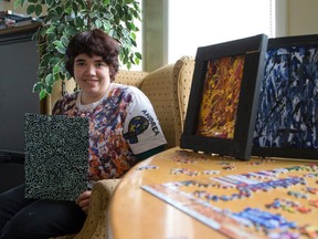 Andrea Koenig, 24, shows off some of her artwork in the common room at the Maple Village apartments on Hamilton Rd. Koenig, diagnosed with autism at 21, is raising awareness for Autism Spectrum Disorder and raising funds for the London chapter of Autism Ontario through an exhibit and related activities. (CRAIG GLOVER, The London Free Press)